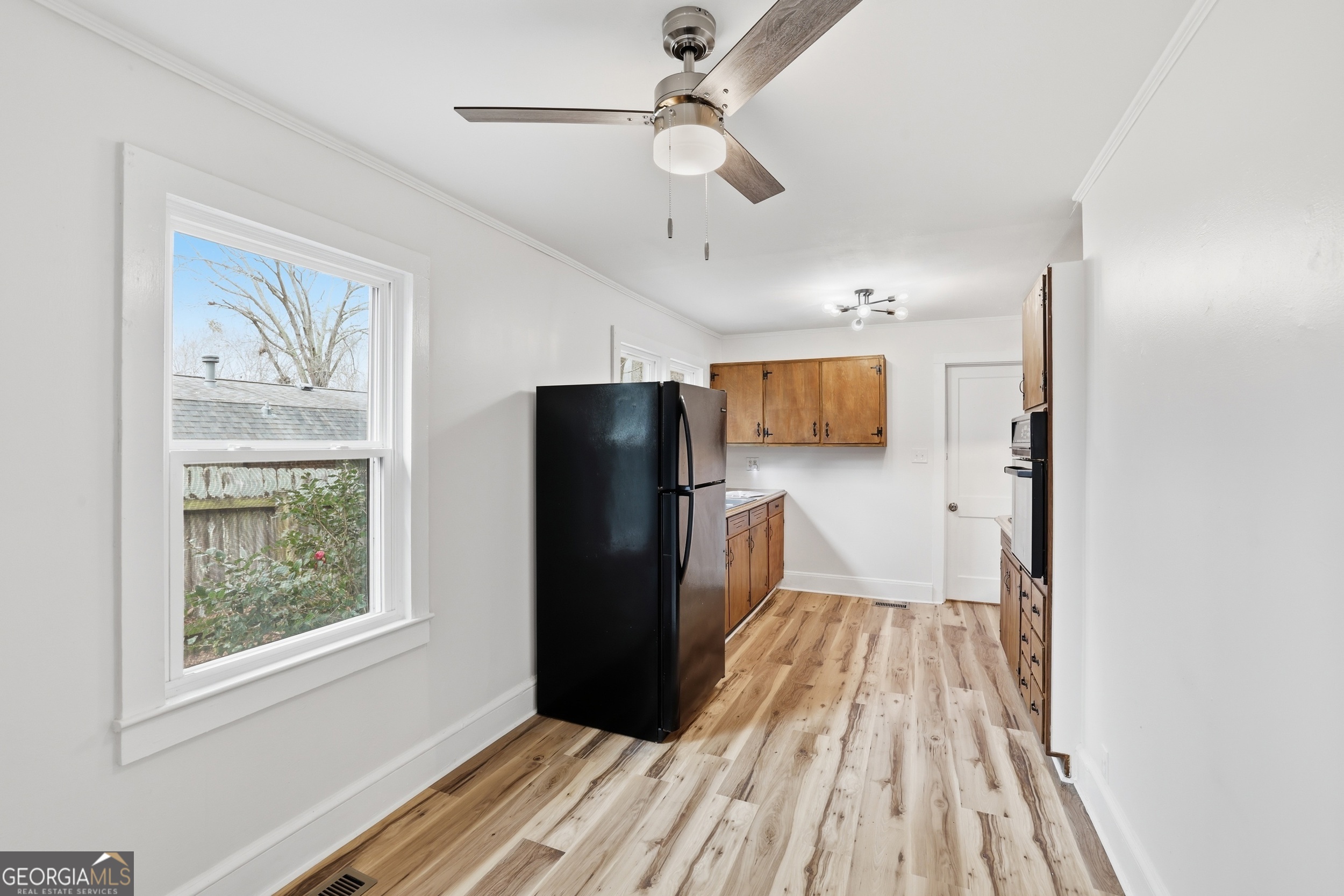 481 Collins Road Toccoa, GA 30577 - Photo 38 of 54 a view of a hallway with wooden floor and a ceiling fan