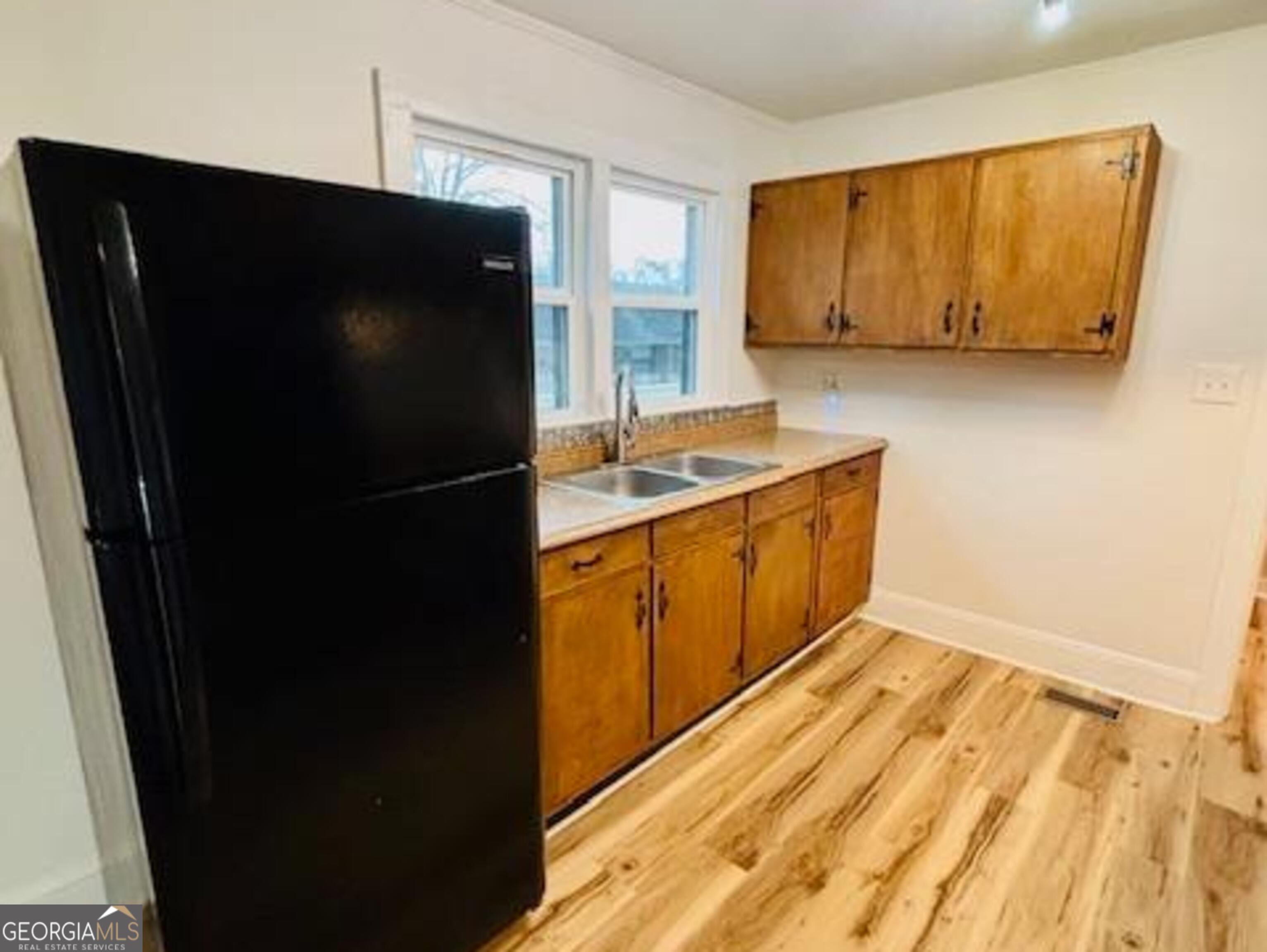 481 Collins Road Toccoa, GA 30577 - Photo 45 of 54 a kitchen with a sink and a refrigerator
