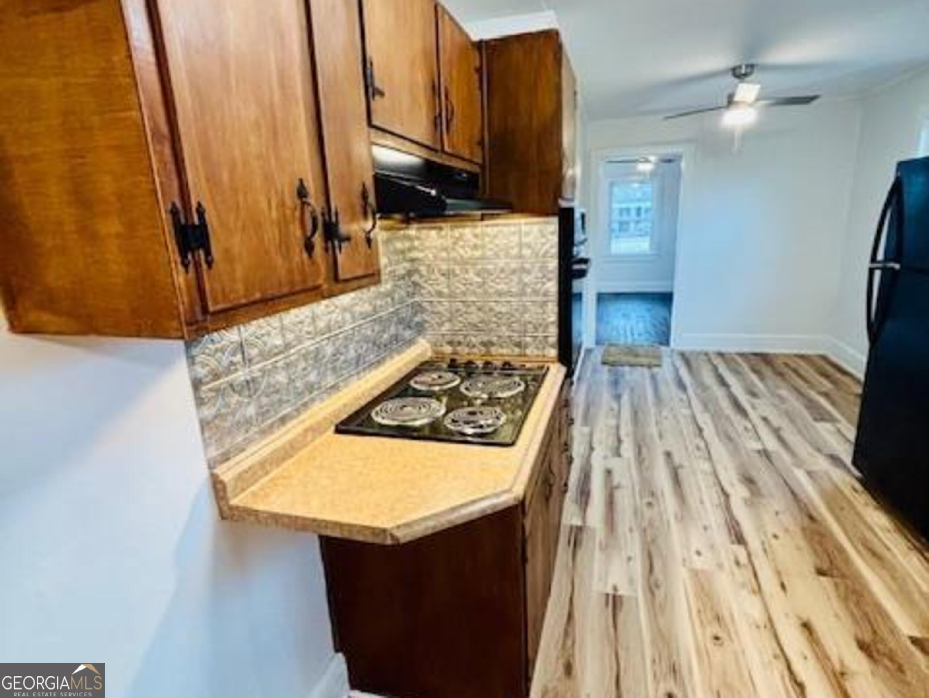 481 Collins Road Toccoa, GA 30577 - Photo 49 of 54 a kitchen with wooden cabinets and a stove