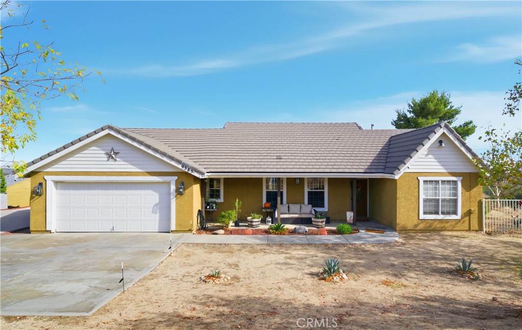 a view of a house with outdoor space and a yard