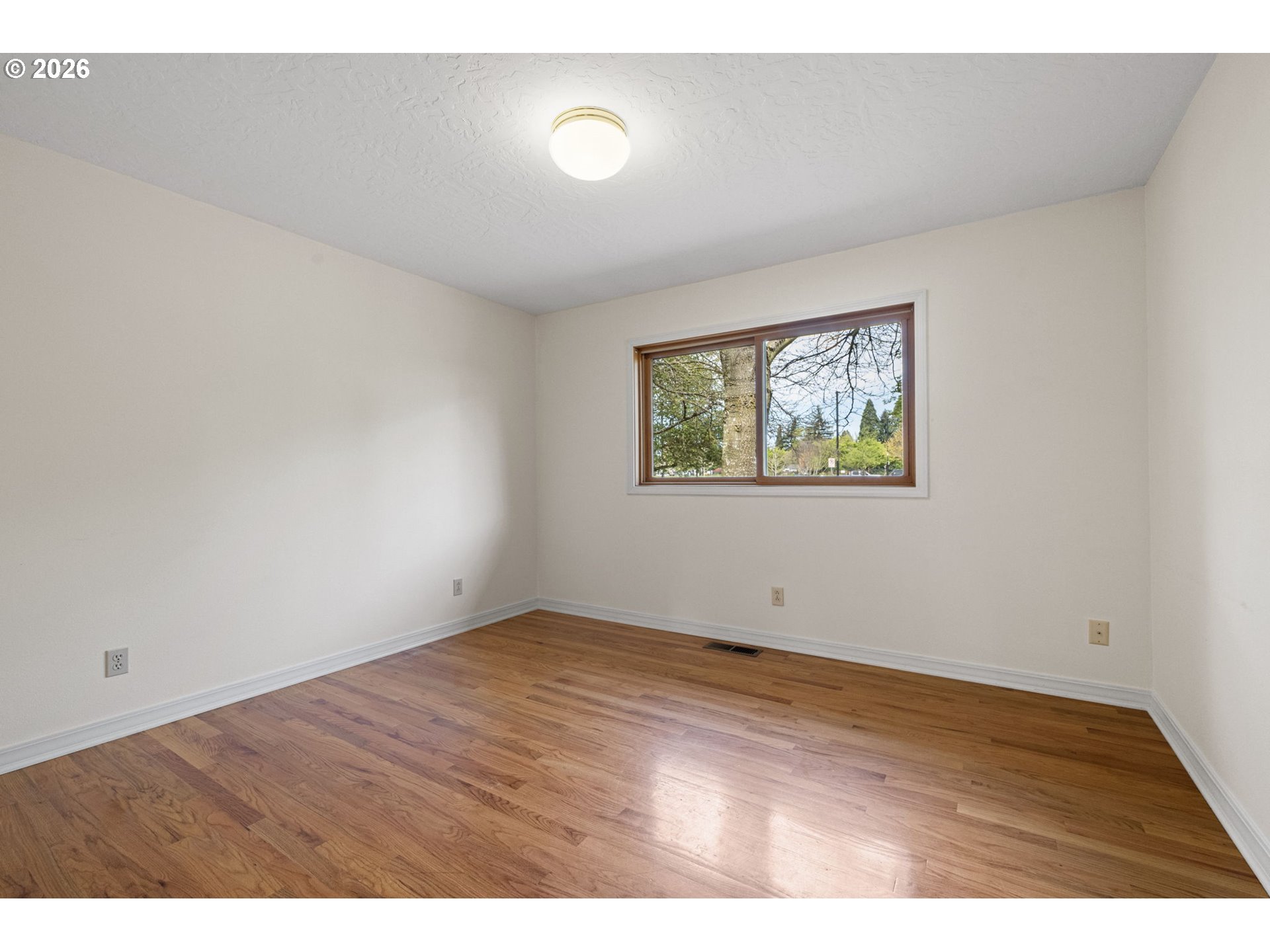 84 Green Lane Eugene, OR 97404 - Photo 28 of 41 a view of an empty room with wooden floor and a window