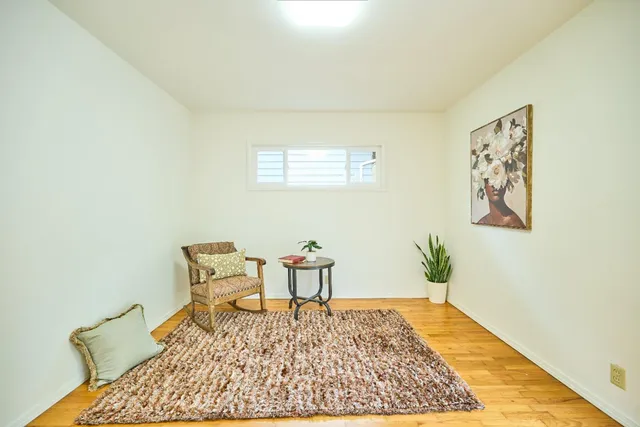 a living room with a couch and a rug