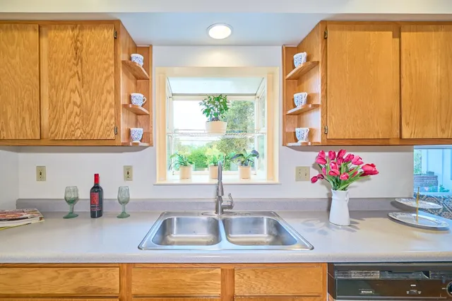 a kitchen with a sink and large window