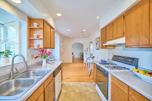 a kitchen with granite countertop a sink and cabinets