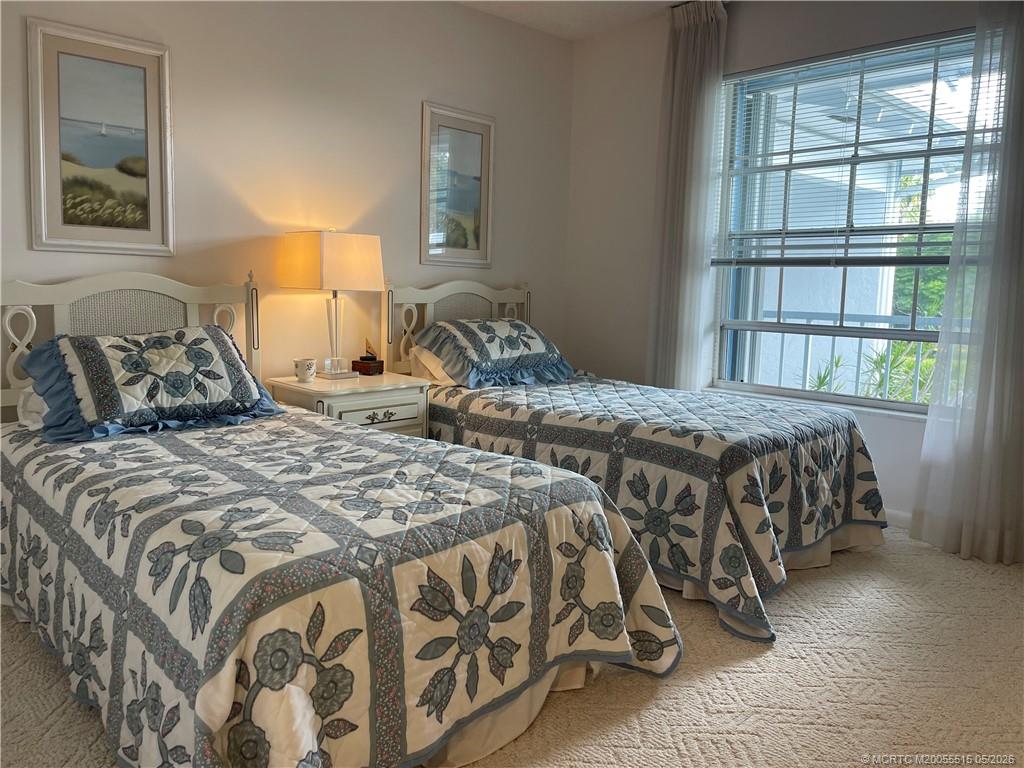 1858 Southwest Palm City Road, Unit 203 Stuart, FL 34994 - Photo 18 of 21 a bedroom with a bed and a window
