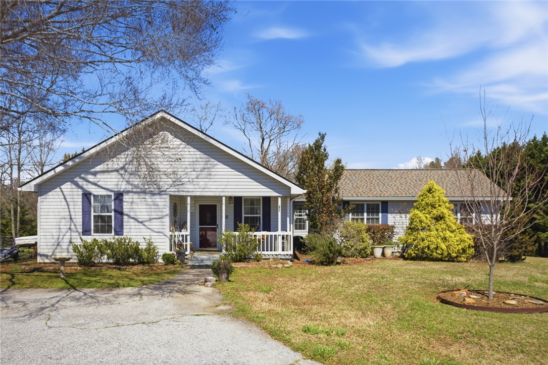 175 Burkett Road Seneca, SC 29672 - Photo 2 of 47 This charming home offers classic appeal with a welcoming front porch and mature landscaping.