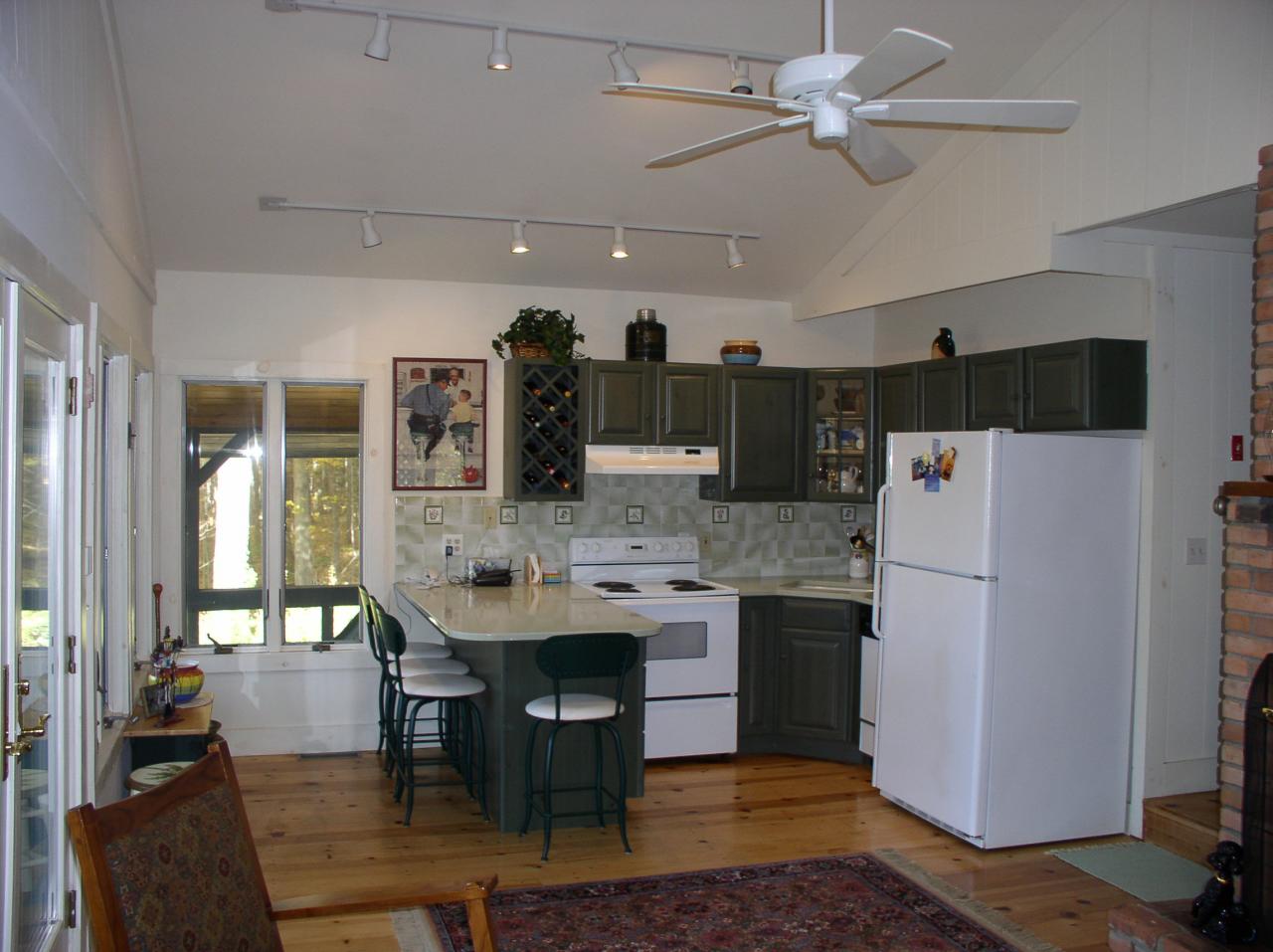 105 Lake Road Richmond, MA 01201 - Photo 3 of 8 a kitchen with stainless steel appliances kitchen island granite countertop a dining table and chairs