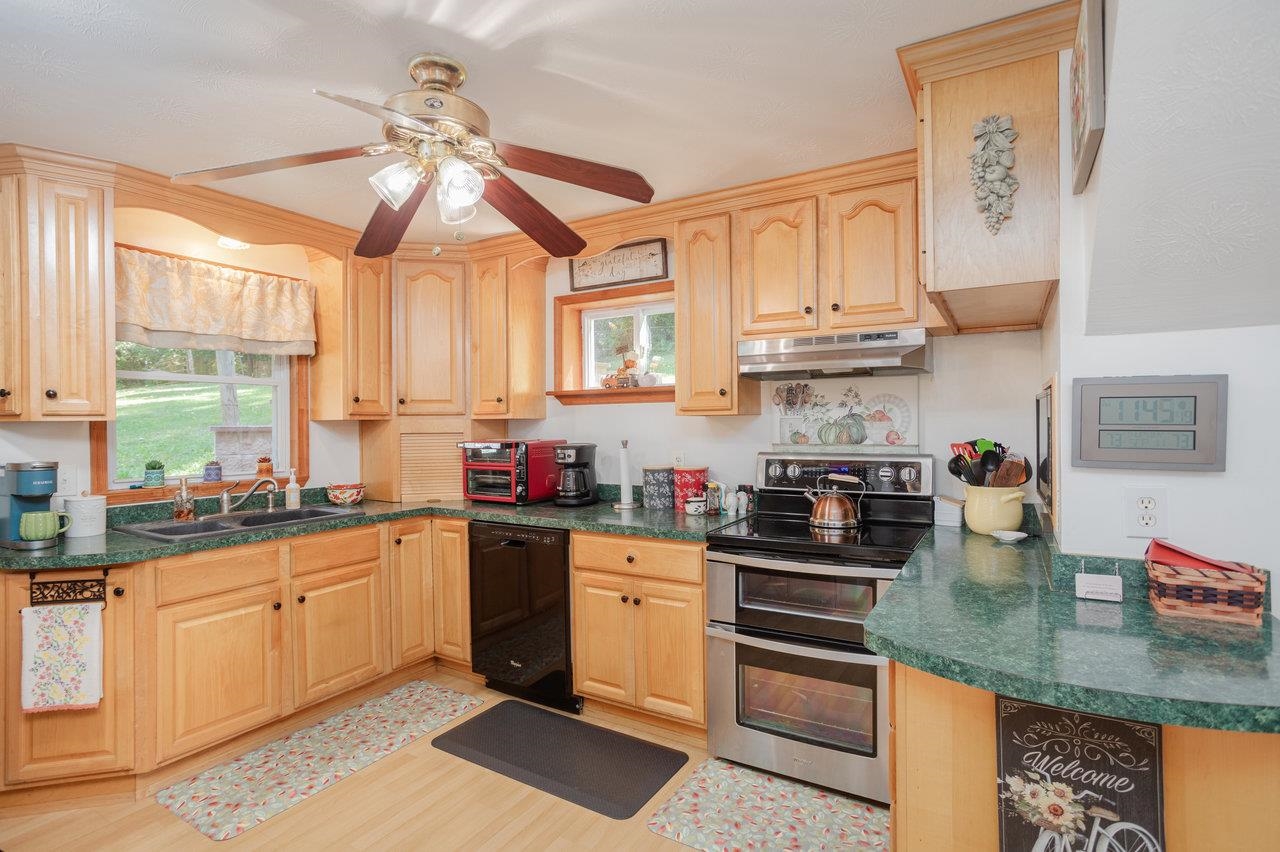 279 Helms Road Stanley, VA 22851 - Photo 16 of 64 a kitchen with stainless steel appliances granite countertop a sink a stove and cabinets