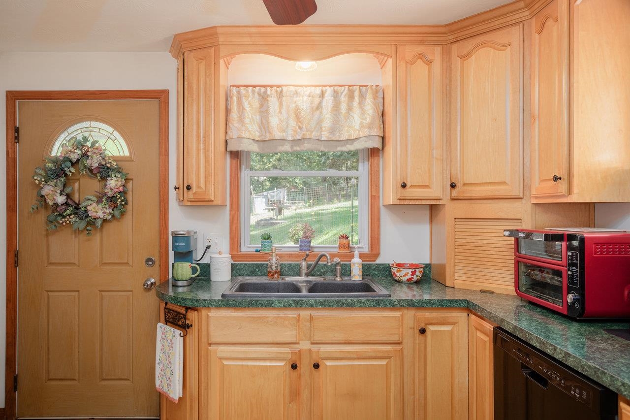 279 Helms Road Stanley, VA 22851 - Photo 17 of 64 a kitchen with stainless steel appliances granite countertop a stove a sink and a microwave
