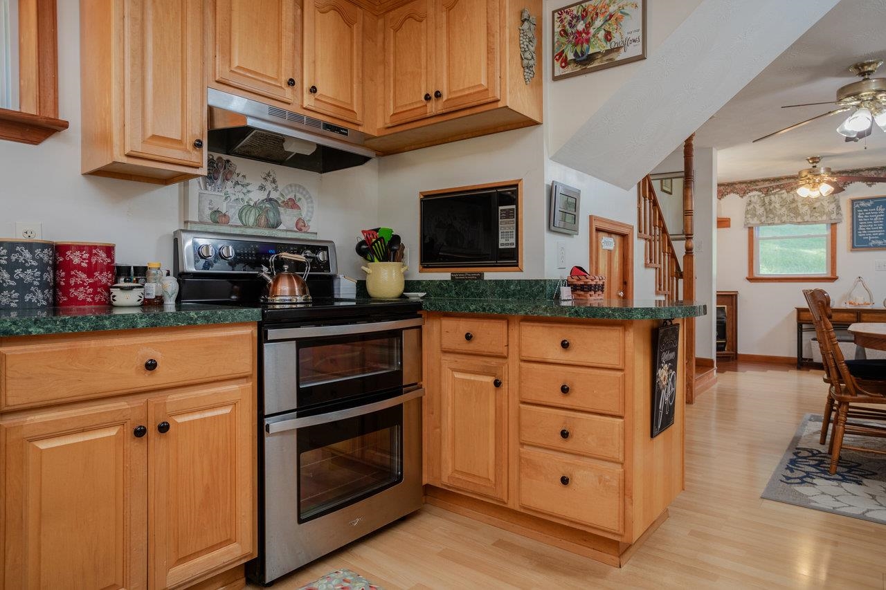 279 Helms Road Stanley, VA 22851 - Photo 20 of 64 a kitchen with stainless steel appliances granite countertop a stove and cabinets