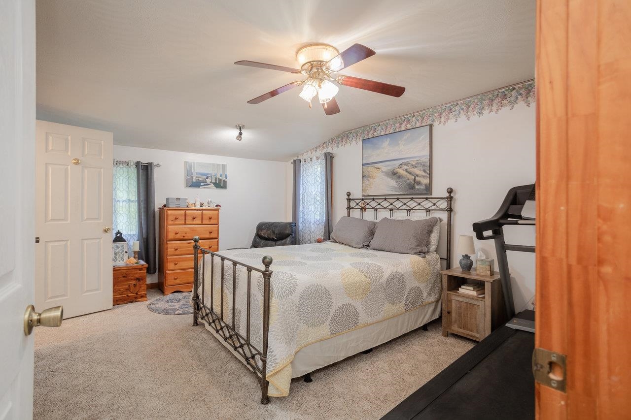 279 Helms Road Stanley, VA 22851 - Photo 29 of 64 a bedroom with a bed and a chandelier