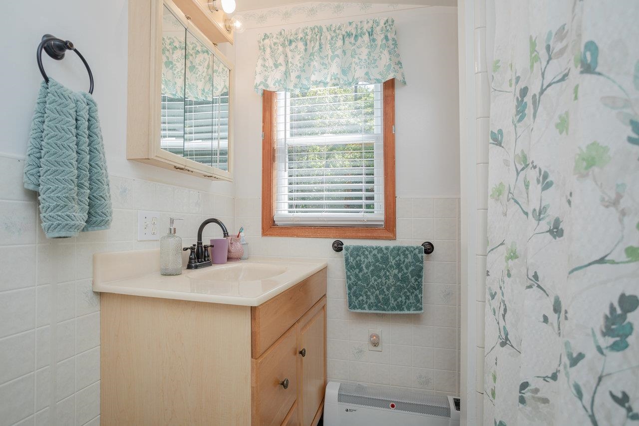 279 Helms Road Stanley, VA 22851 - Photo 33 of 64 a bathroom with a granite countertop sink and a mirror