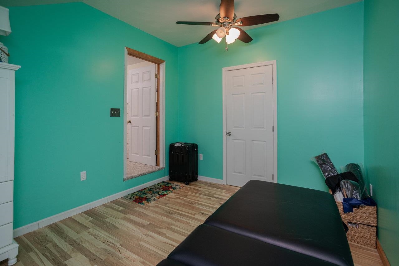 279 Helms Road Stanley, VA 22851 - Photo 41 of 64 a bedroom with a bed and a chandelier