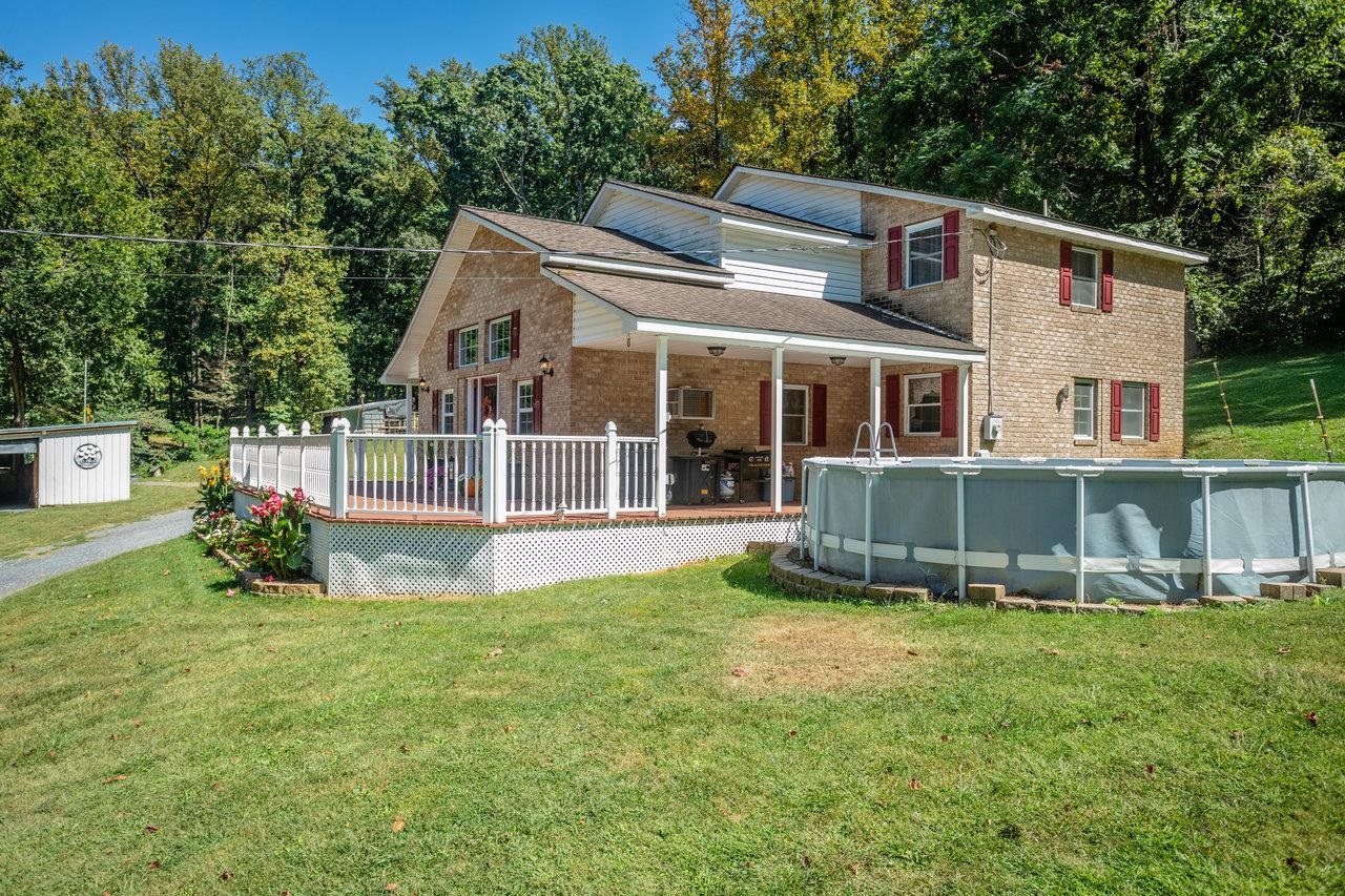 279 Helms Road Stanley, VA 22851 - Photo 51 of 64 a view of a house with a yard and sitting area