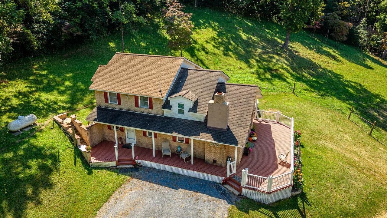 279 Helms Road Stanley, VA 22851 - Photo 55 of 64 aerial view of a house with table and chairs under an umbrella
