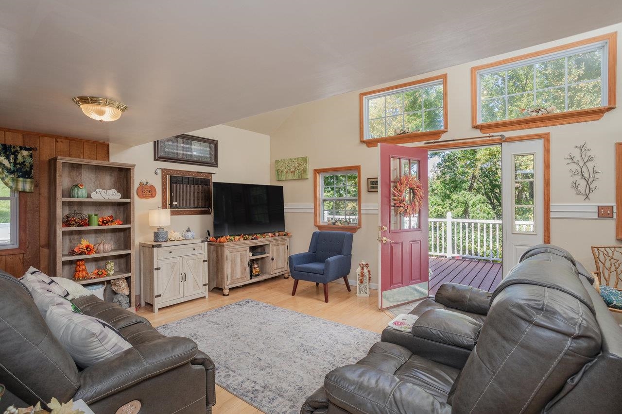 279 Helms Road Stanley, VA 22851 - Photo 6 of 64 a living room with furniture a flat screen tv and a large window