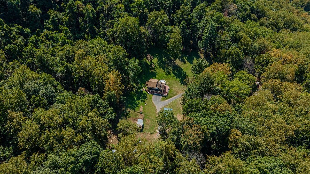 279 Helms Road Stanley, VA 22851 - Photo 63 of 64 an aerial view of a house with a yard and large trees