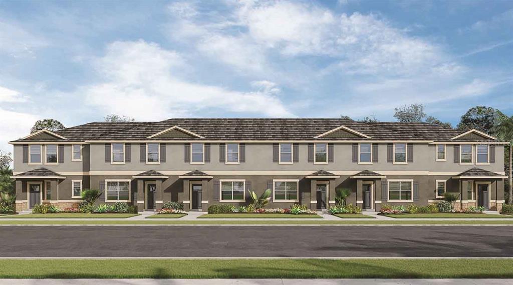 17085 Water Spring Boulevard Winter Garden, FL 34787 - Photo 1 of 1 a front view of a white building with a garden and plants