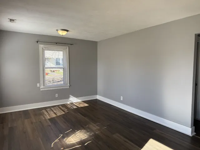 a view of wooden floor and chandelier in a room