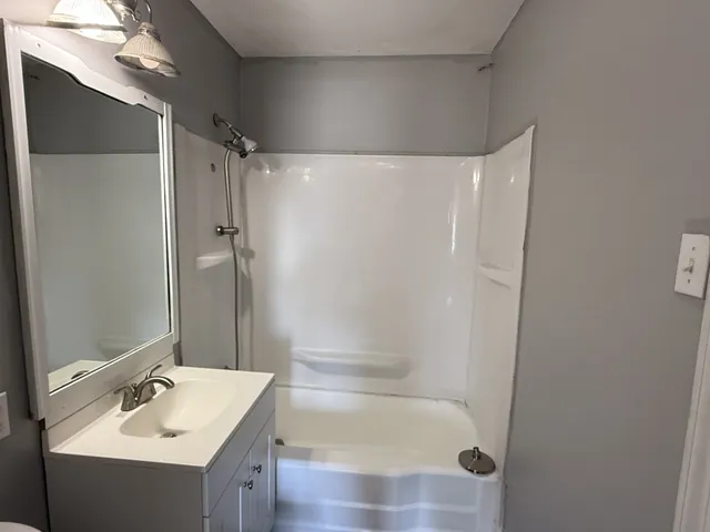 a bathroom with a sink mirror toilet and bathtub