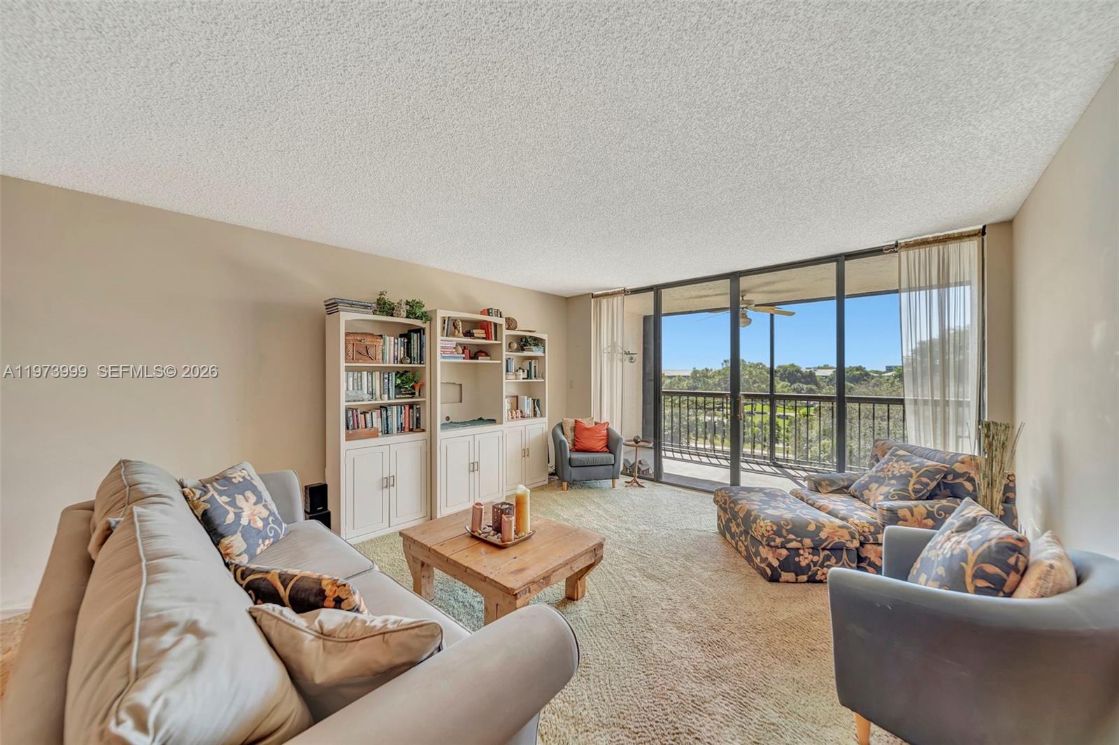 6620 Boca Del Mar Drive, Unit 502 Boca Raton, FL 33433 - Photo 20 of 52 Living room with wall of sliders leading to screened balcony