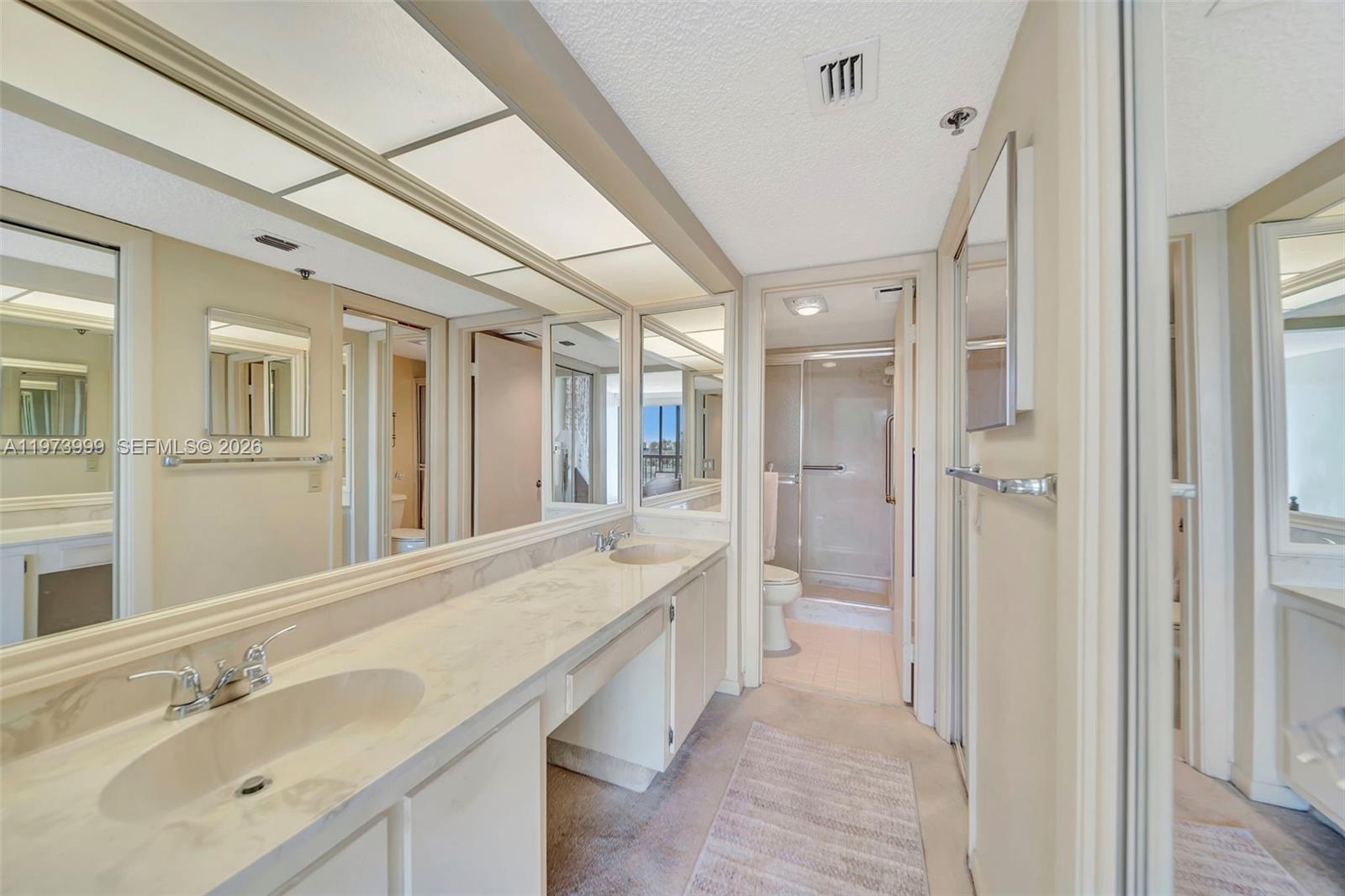 6620 Boca Del Mar Drive, Unit 502 Boca Raton, FL 33433 - Photo 34 of 52 Primary bathroom with dual sinks and vanity area