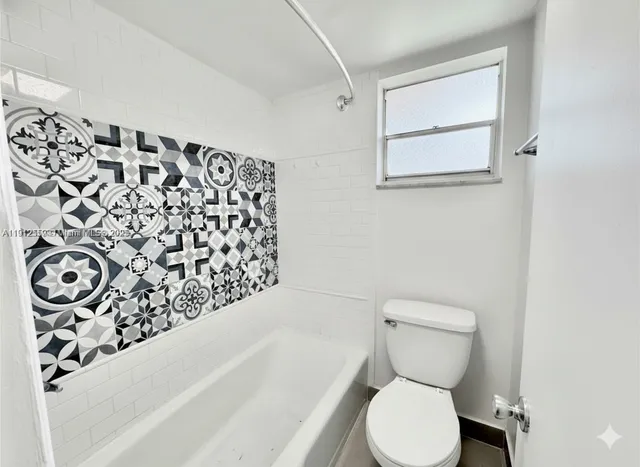 a bathroom with a toilet and a bathtub