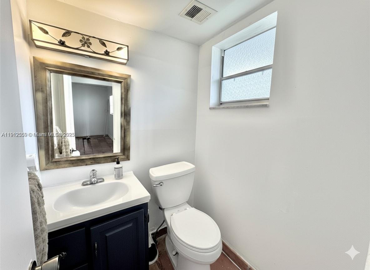 14901 Southwest 4th Street, Unit 5A Pembroke Pines, FL 33027 - Photo 12 of 21 a bathroom with a toilet sink vanity and mirror