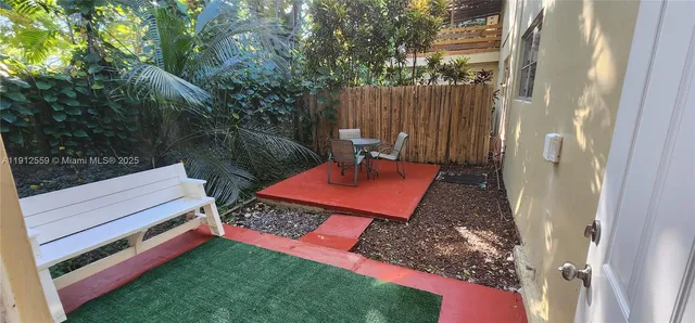 a backyard of a house with yard fire pit and outdoor seating