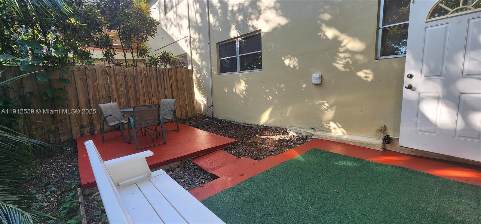 14901 Southwest 4th Street, Unit 5A Pembroke Pines, FL 33027 - Photo 20 of 21 a backyard of a house with table and chairs