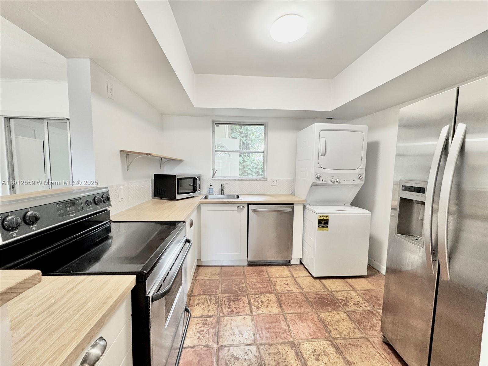 14901 Southwest 4th Street, Unit 5A Pembroke Pines, FL 33027 - Photo 3 of 21 a kitchen that has a sink a counter top space stainless steel appliances and cabinets
