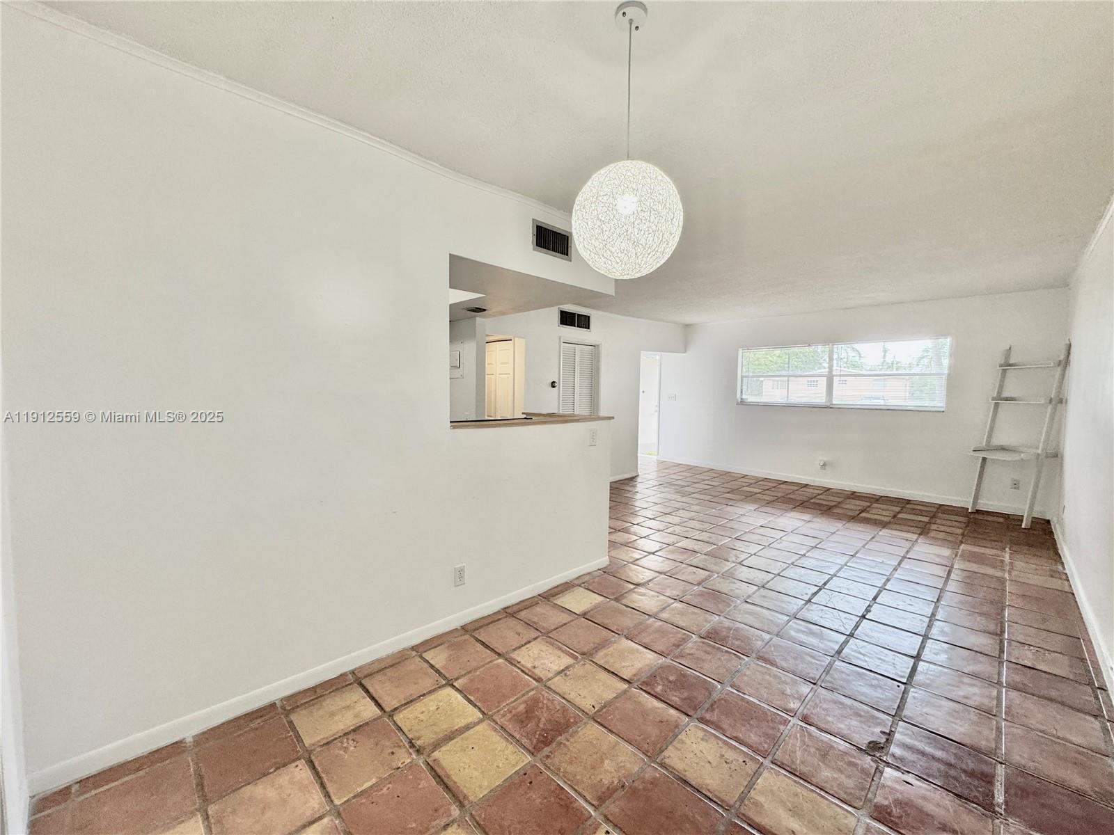 14901 Southwest 4th Street, Unit 5A Pembroke Pines, FL 33027 - Photo 6 of 21 a view of an empty room with window and wooden floor