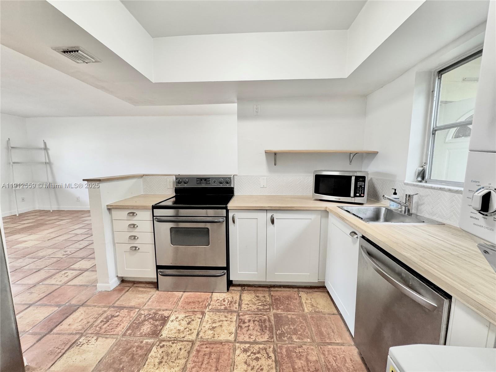 14901 Southwest 4th Street, Unit 5A Pembroke Pines, FL 33027 - Photo 8 of 21 a kitchen with a stove and a sink
