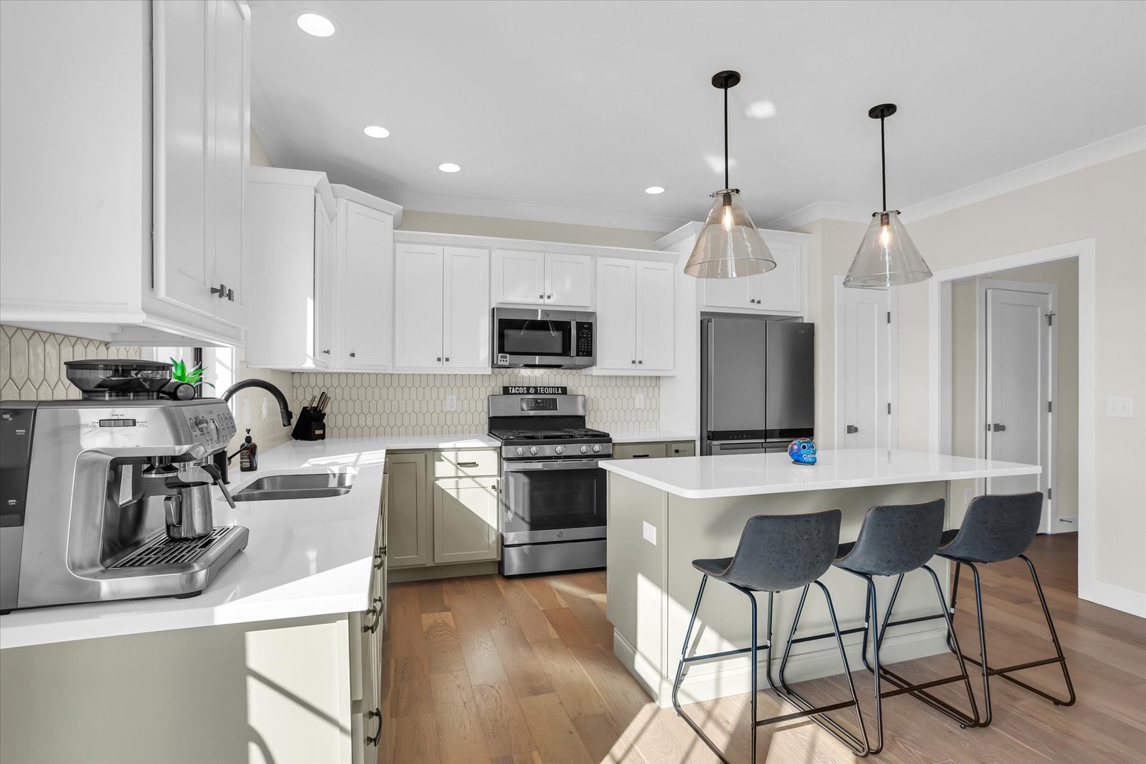 409 Sutton Street Savoy, IL 61874 - Photo 12 of 40 a kitchen with kitchen island white cabinets and stainless steel appliances