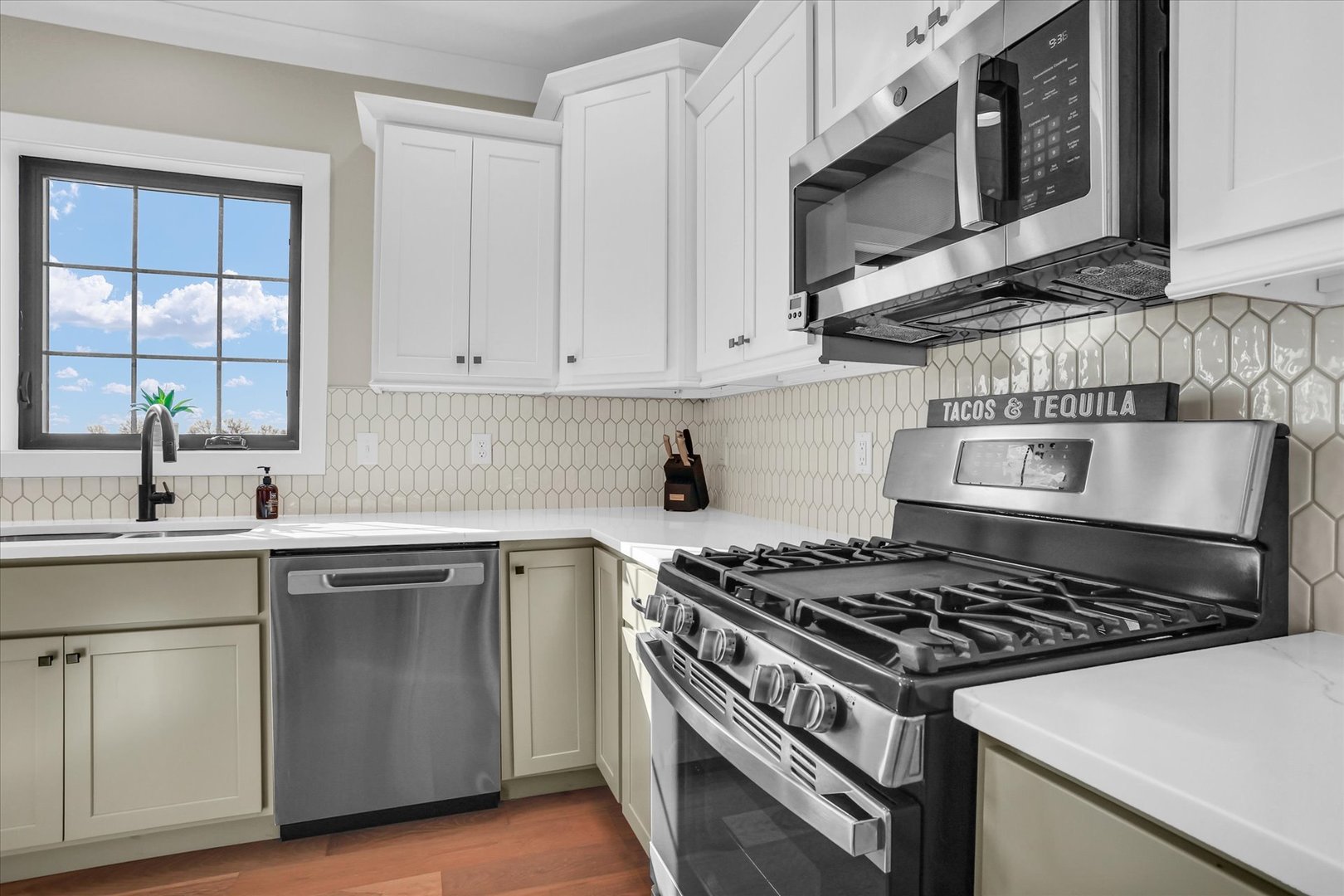 409 Sutton Street Savoy, IL 61874 - Photo 13 of 40 a kitchen with stainless steel appliances granite countertop a stove and a microwave