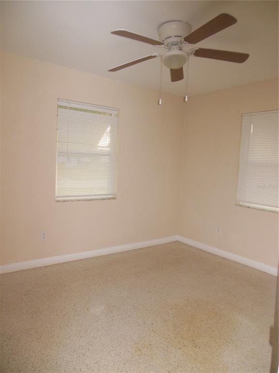 975 Shorecrest Avenue Deltona, FL 32725 - Photo 11 of 11 an empty room with a window and a fan