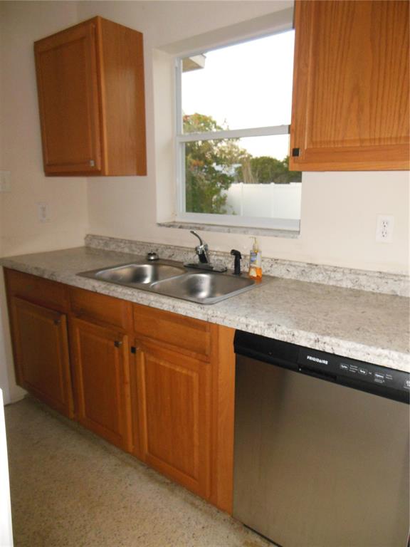 975 Shorecrest Avenue Deltona, FL 32725 - Photo 3 of 11 a kitchen with sink cabinets and window
