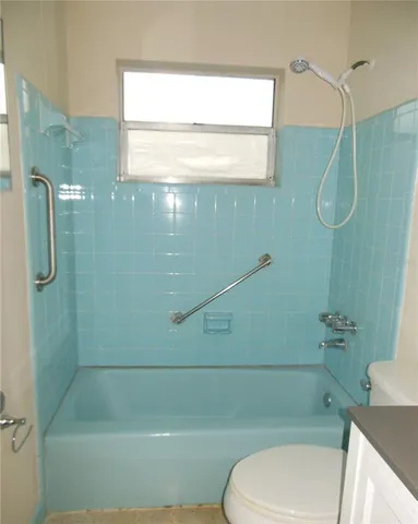 a bathroom with a toilet and shower
