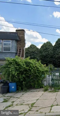 a view of a door and chair in the back yard