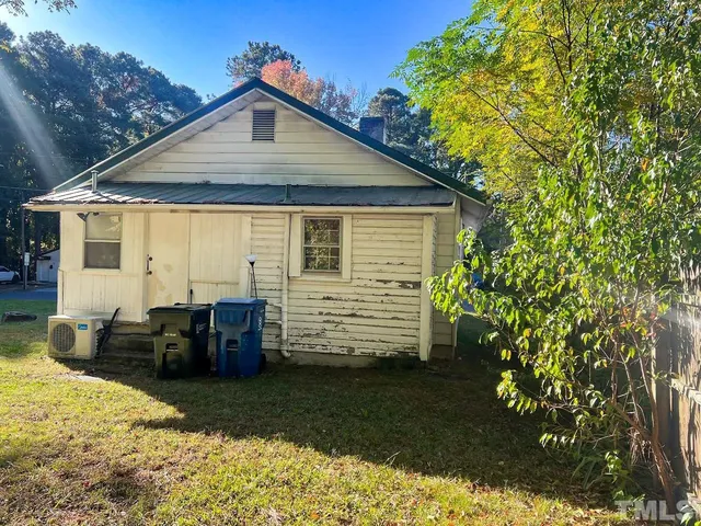 a front view of house with a garden