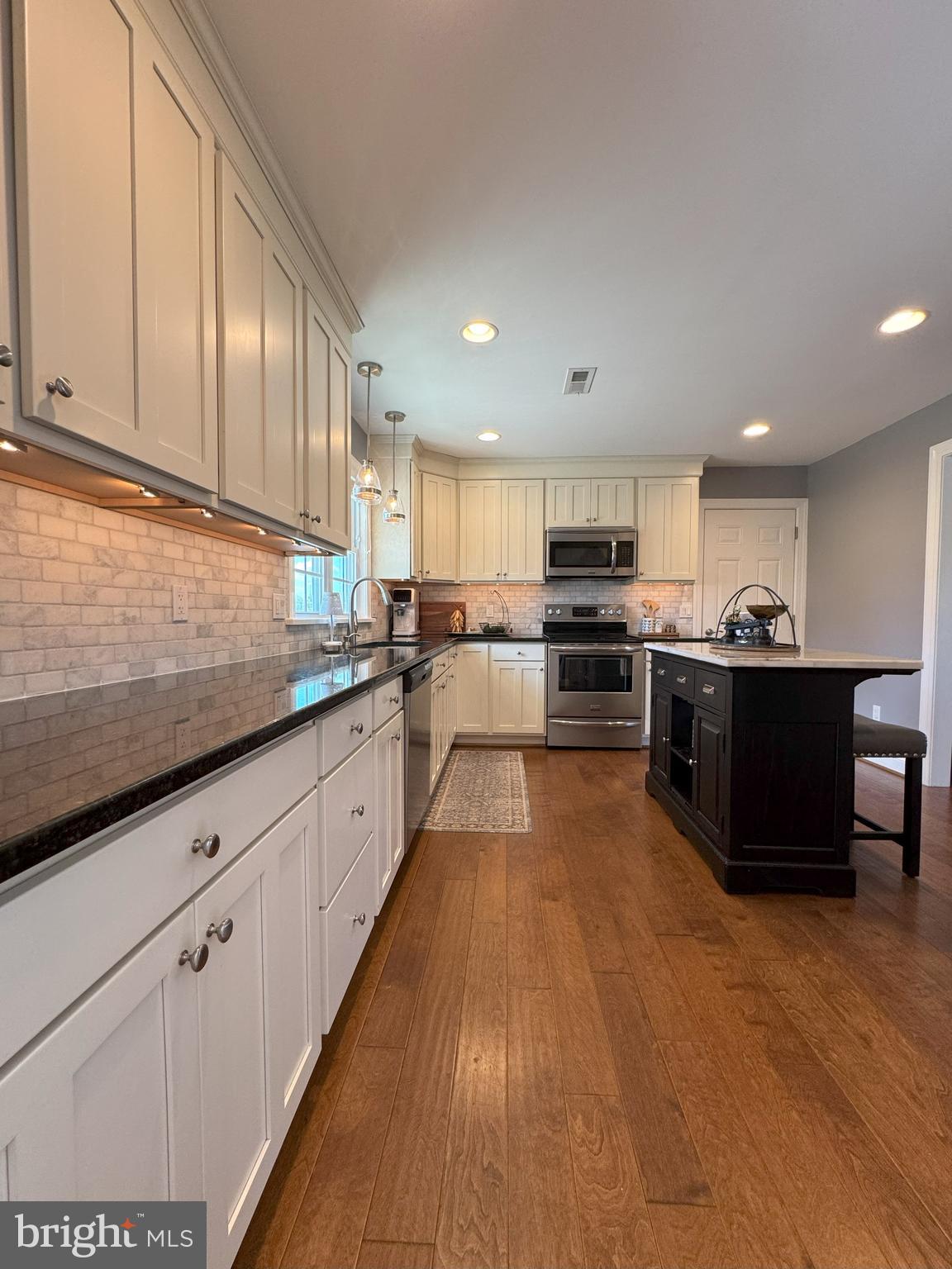 61 Rose Apple Road Levittown, PA 19056 - Photo 12 of 33 a large kitchen with stainless steel appliances granite countertop a stove and a sink
