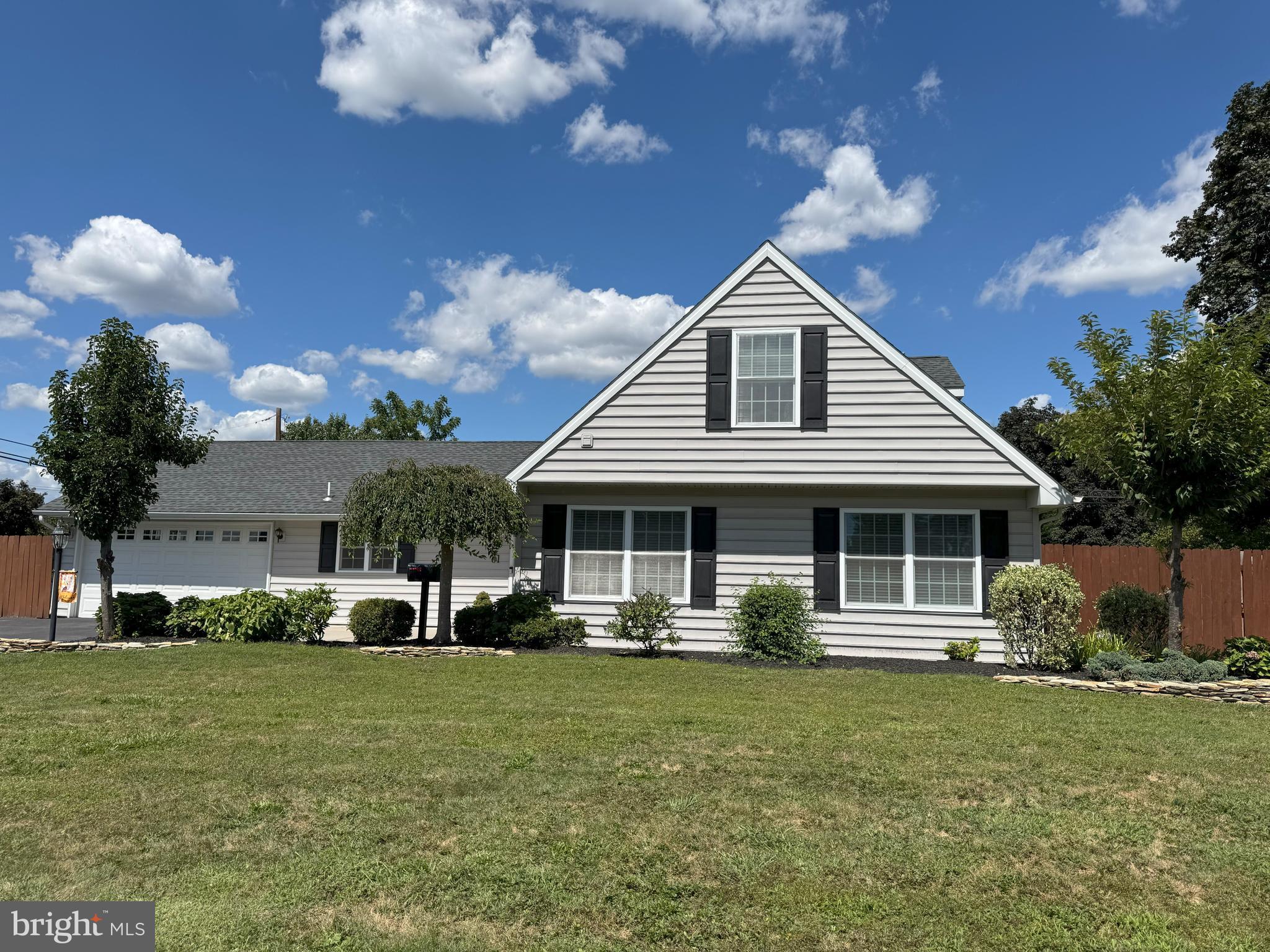 61 Rose Apple Road Levittown, PA 19056 - Photo 31 of 33 a front view of a house with a garden and trees