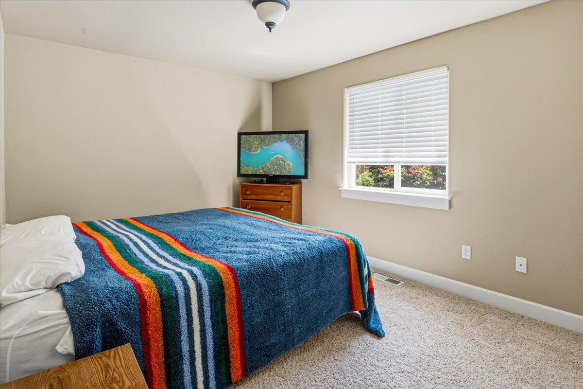 1339 Southwest Rimrock Way Redmond, OR 97756 - Photo 13 of 26 a bedroom with a bed and a flat screen tv
