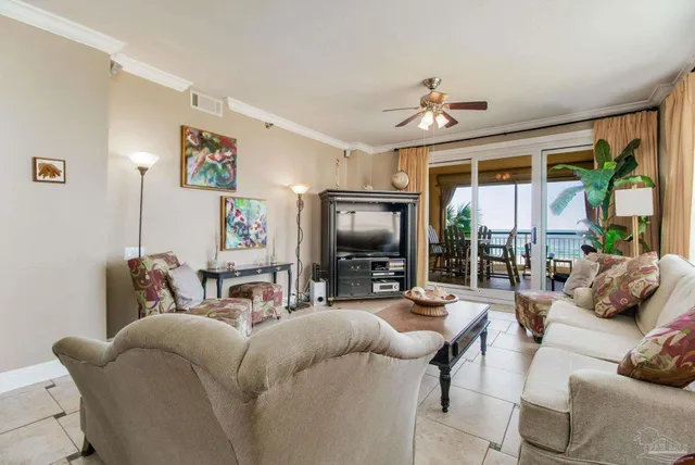 a living room with furniture a flat screen tv and a large window
