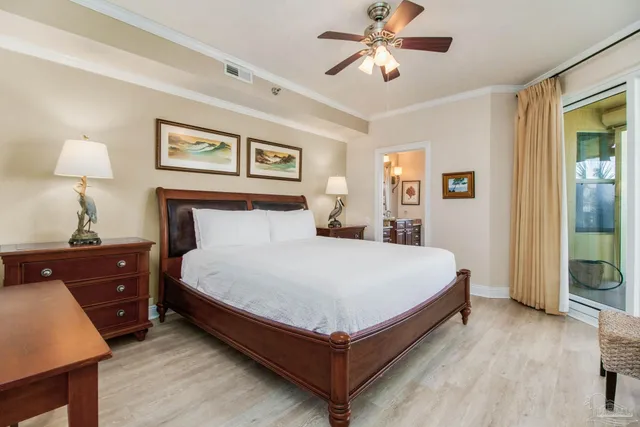 a large bedroom with a bed and wooden floor