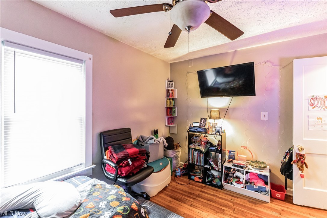 5880 State Road Cleveland, OH 44134 - Photo 13 of 21 Bedroom featuring ceiling fan, a textured ceiling, and light wood-type flooring