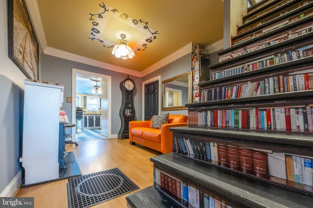 a living room with lots of furniture and a book shelf