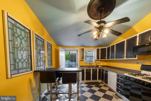 a kitchen with stainless steel appliances granite countertop a stove and a large window