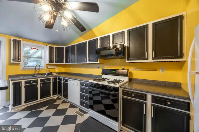 a kitchen with stainless steel appliances a stove and a microwave