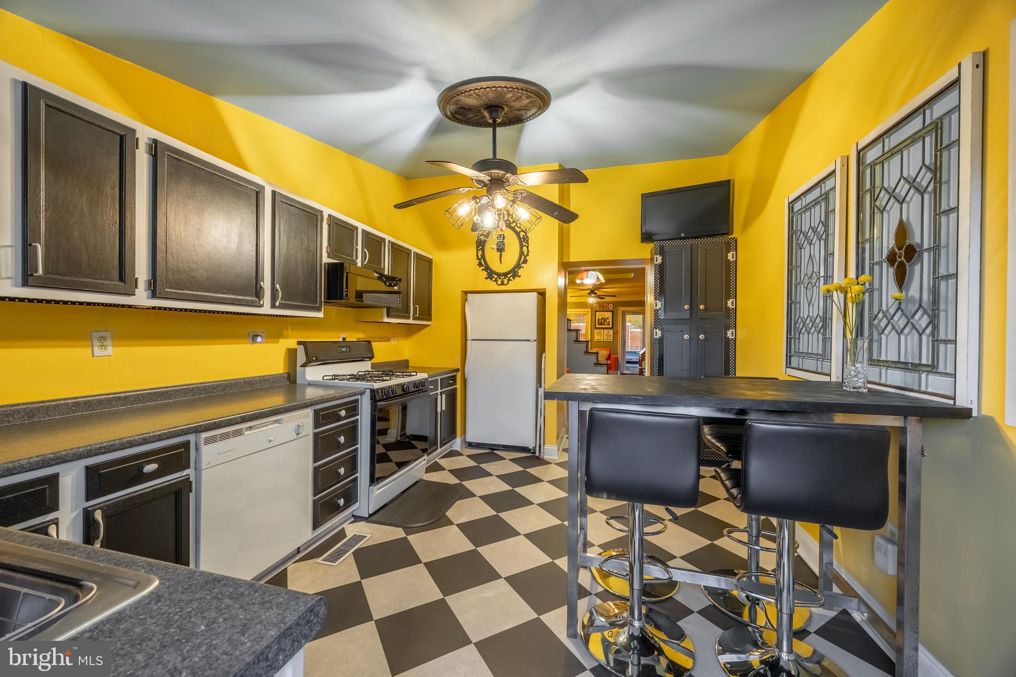 3450 Keswick Road Baltimore, MD 21211 - Photo 14 of 35 a kitchen with a stove a sink and a microwave